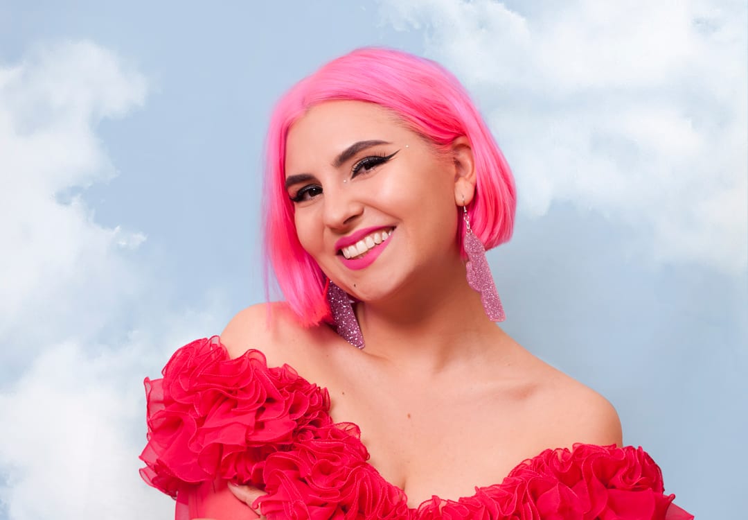 Ruby Rare in a pink wig and red dress.