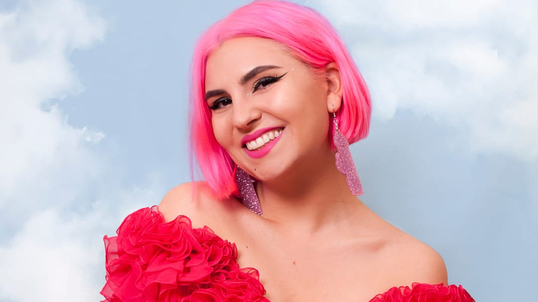 Ruby Rare in a pink wig and red dress.