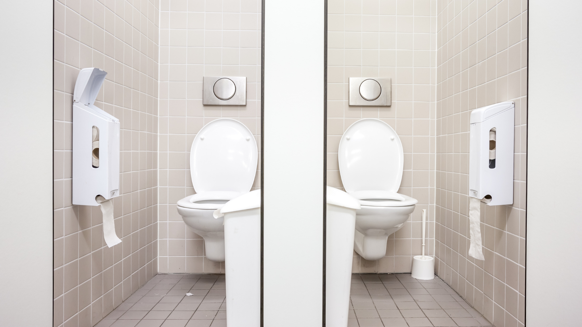 Toilet cubicles in a workplace setting — highlighting the need for free and accessible period products to support menstrual health at work