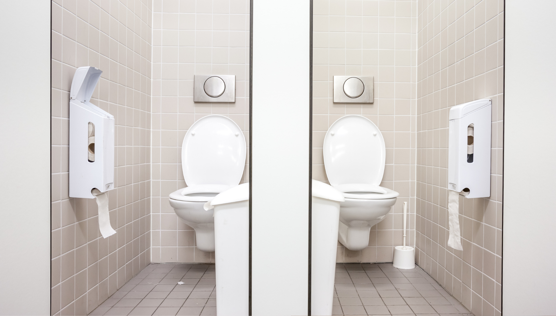 Toilet cubicles in a workplace setting — highlighting the need for free and accessible period products to support menstrual health at work