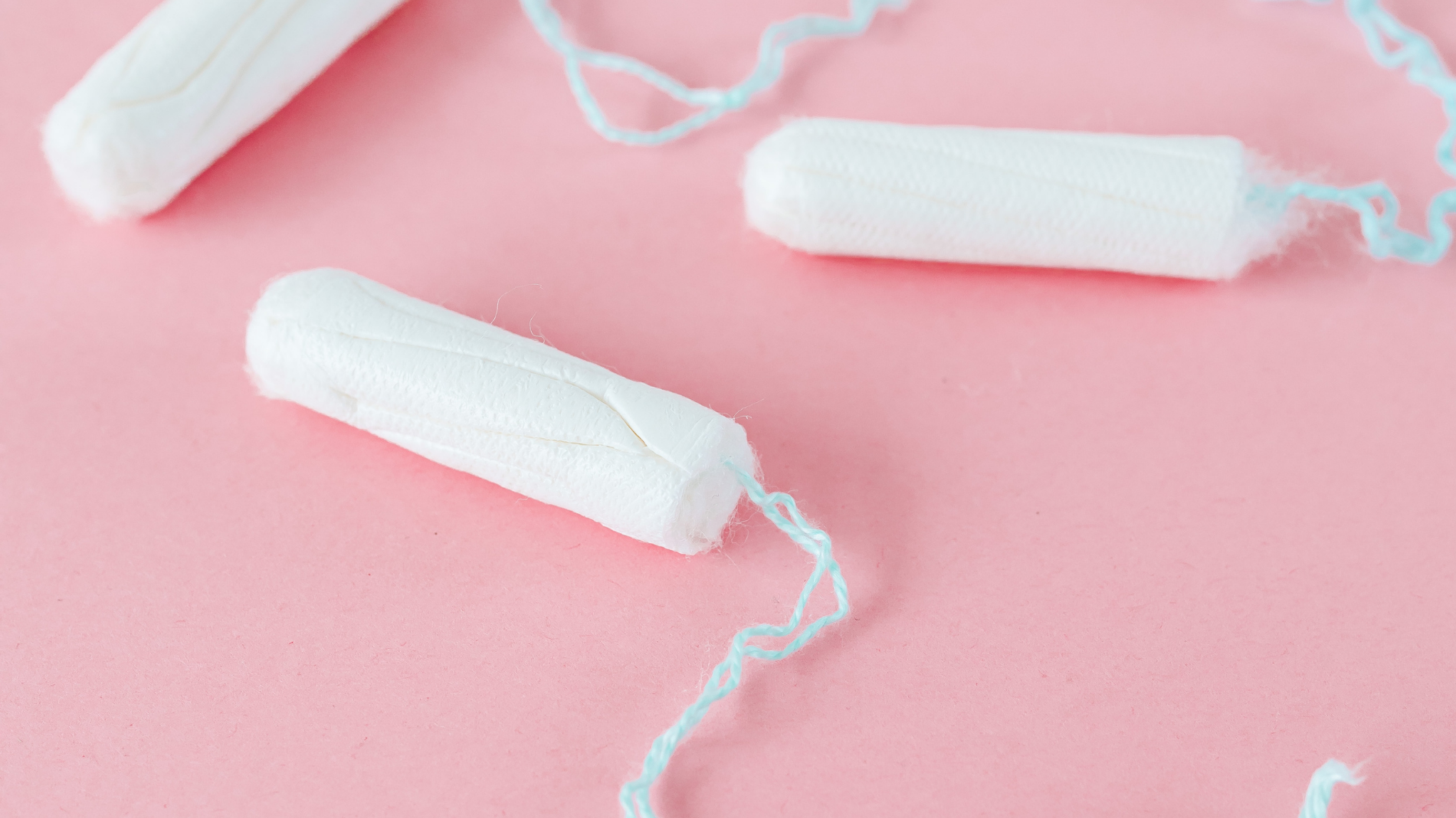 Tampons on a pink background — supporting blog about why you shouldn’t flush tampons, how to dispose of them responsibly, and the environmental impact of improper tampon disposal