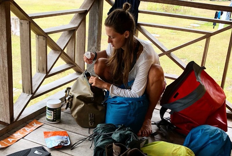 A traveller in South America pulling a Mooncup menstrual cup out of their bag.