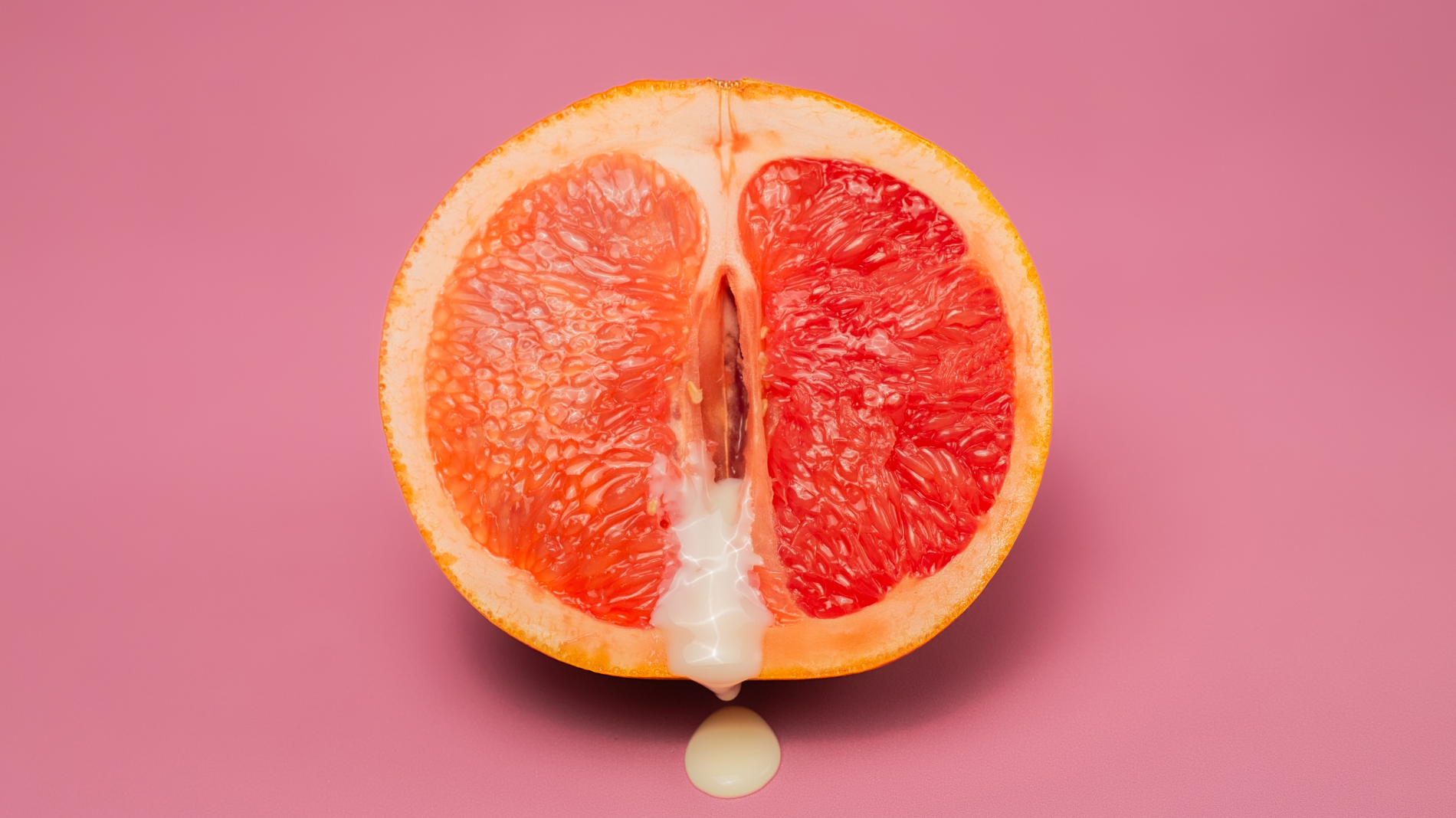 Halved grapefruit with white fluid representing vaginal discharge — supporting blog about causes of smelly discharge, vaginal odour, and common infections like BV and thrush