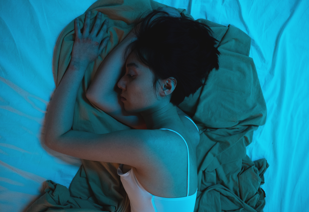 Woman sleeping on bed.