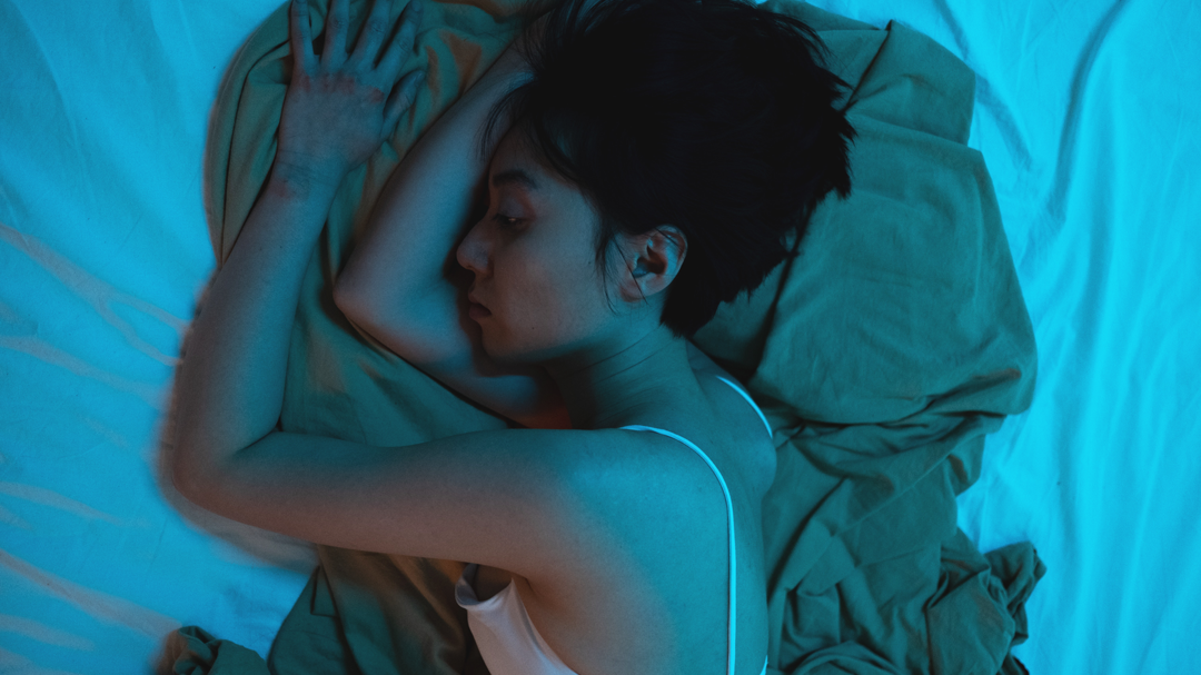 Woman sleeping on bed.