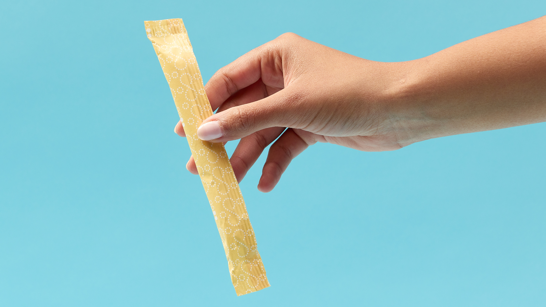 organic cotton tampon against blue backdrop