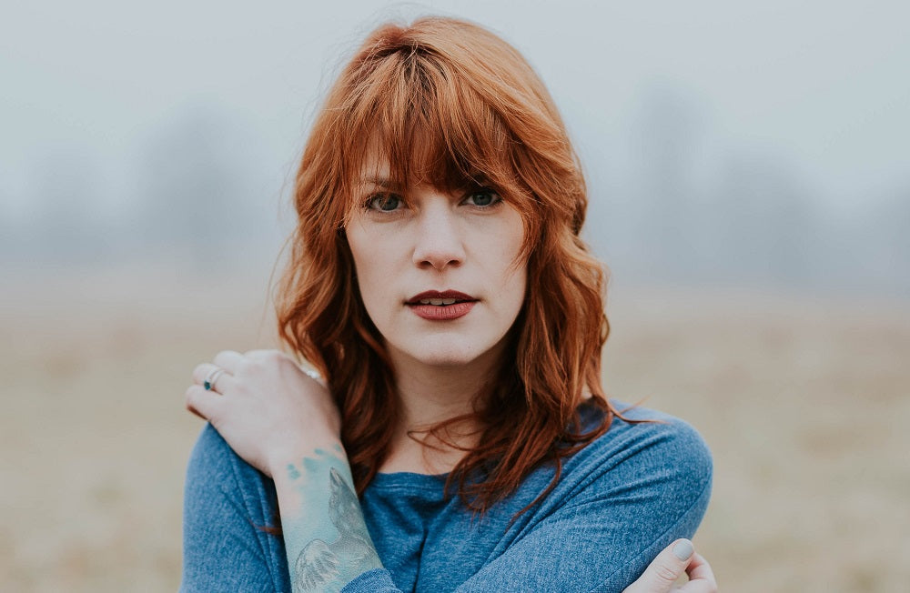 Portrait of a mature woman with red hair.