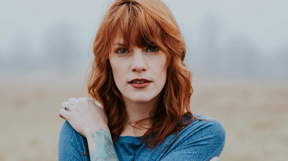 Portrait of a mature woman with red hair.